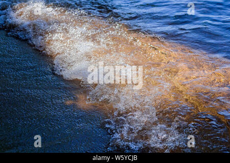 Sun Shining on Waves Rolling in at Emerald Bay, South Lake Tahoe, California Stock Photo