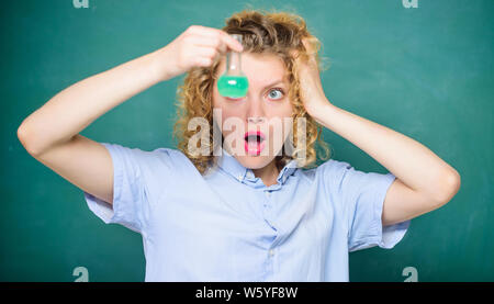 biology experiment. sample formula. surprised student with beaker. chemistry research results. girl hold chemical flask with liquid. scientist at school lab. school lesson. Educational concept. Stock Photo