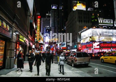 NEW YORK, USA. February 2009. people walking around times square in manhattan at night. Stock Photo