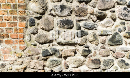 wall of field stones and red bricks Stock Photo