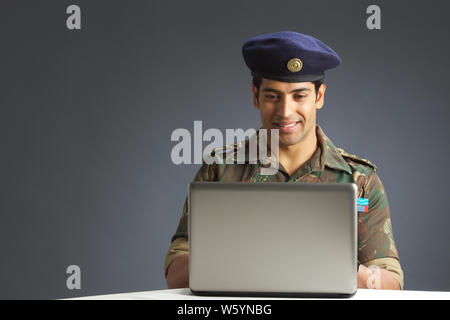 Army Soldier working on a laptop Stock Photo