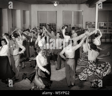 1940s 1950s ROOM FULL OF COUPLES MEN AND WOMEN WEARING WESTERN ATTIRE SQUARE DANCING  - d2998 LAN001 HARS CELEBRATION FEMALES MARRIED RURAL SPOUSE HUSBANDS HEALTHINESS COPY SPACE FULL-LENGTH LADIES PHYSICAL FITNESS PERSONS INSPIRATION TRADITIONAL MALES WESTERN ENTERTAINMENT B&W PARTNER WIDE ANGLE ACTIVITY HAPPINESS PHYSICAL LEISURE STRENGTH AND EXCITEMENT RECREATION DIRECTION COUNTRY AND WESTERN OF CONNECTION CONCEPTUAL FLEXIBILITY MUSCLES STYLISH ATTIRE MID-ADULT MID-ADULT MAN MID-ADULT WOMAN PRECISION RELAXATION TOGETHERNESS WIVES BLACK AND WHITE CAUCASIAN ETHNICITY OLD FASHIONED Stock Photo