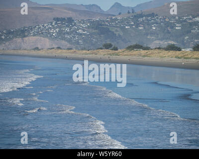 View along New Brighton beach with people walking in the distance Stock Photo