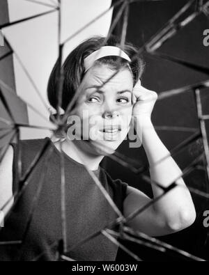 1960s COMPOSITE IMAGE UPSET WOMAN BROKEN MIRROR - s19062 HAR001 HARS FRIGHTENED B&W SADNESS ANXIETY HEAD AND SHOULDERS ANXIOUS DISTRESSED IMAGE IRATE COMPOSITE DESPAIR MENTAL HEALTH CONCEPTUAL THREATENED FEARFUL UNEASY DISPLEASURE HOSTILITY TENSION ANNOYANCE DISAPPOINTED EMOTION EMOTIONAL EMOTIONS IRRITATED MID-ADULT MID-ADULT WOMAN MISERABLE BLACK AND WHITE CAUCASIAN ETHNICITY DISPLEASED DISTRAUGHT DISTURBED HAR001 HOSTILE INCENSED MENTAL ILLNESS OLD FASHIONED Stock Photo