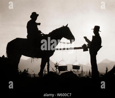 1930s 2 ANONYMOUS SILHOUETTED MEN ONE ON HORSEBACK DRINKING CUPS OF COFFEE AT CAMPFIRE GLACIER NATIONAL PARK FIFTY MT. CAMP USA - s5042 HAR001 HARS WESTERN CUPS SILHOUETTES TRANSPORTATION CAMPFIRE B&W OUTLINE COWBOYS HORSEBACK ADVENTURE SILHOUETTED PARKS RECREATION GLACIER OCCUPATIONS CONNECTION CONCEPTUAL MT ANONYMOUS FIFTY NATIONAL PARK COOPERATION MID-ADULT MID-ADULT MAN MT. NATIONAL PARK SERVICE TOGETHERNESS BLACK AND WHITE HAR001 OLD FASHIONED Stock Photo