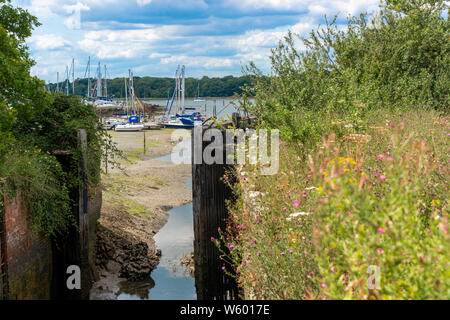 Chichester Canal Lock Gates in summer looking towards Birdham Pool Marina at low tide, Chichester Harbour, West Sussex, England, United Kingdom Stock Photo