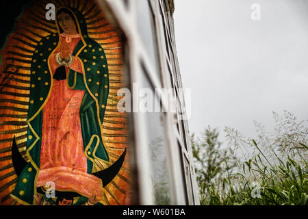 Chapel with religious images. Mural with the image of the virgin Marita, Virgin of Guadalupe in the middle of the landscape, Sonora, Mexico.  Capilla con Imagenes religiosas. Mural con la imagen de la virgen Marita, Virgen de Guadalupe en el medio del paisaje Stock Photo