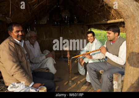 Group of rural people sitting together Stock Photo