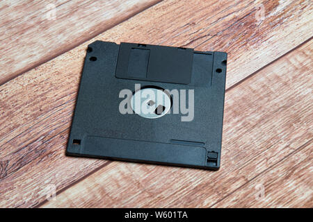 black floppy disk old format. photo on wooden background Stock Photo