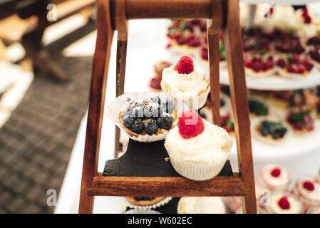Tasty raspberry muffin with cream on a buffet Stock Photo