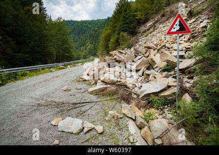 Well predicted falling rocks danger risk road zone Stock Photo