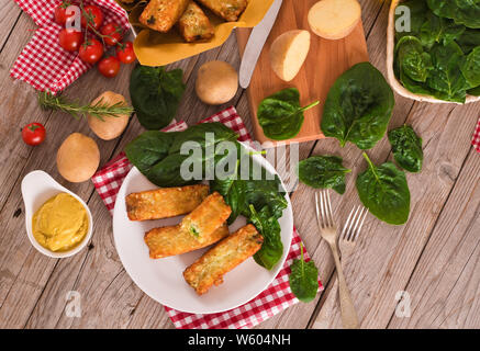 Potato croquettes with spinach and mozzarella. Stock Photo