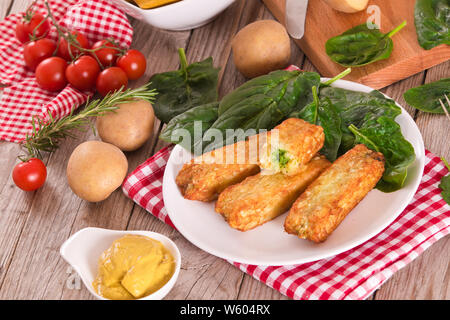 Potato croquettes with spinach and mozzarella. Stock Photo