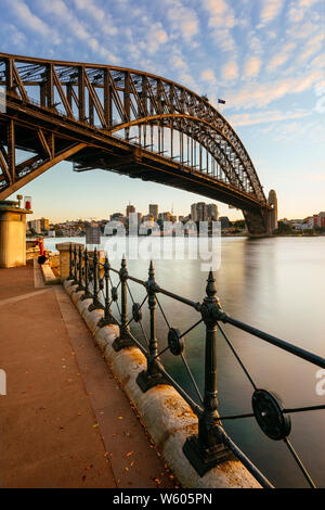 Vertical image of the Sydney Harbour Bridge in Sydney, Australia at sunrise from Hickson Road Reserve. Stock Photo