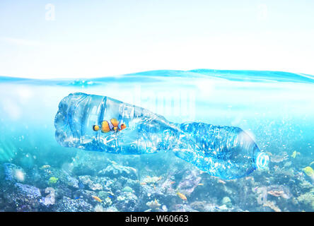 Fish trapped inside a bottle. Problem of plastic pollution under the sea concept. Stock Photo