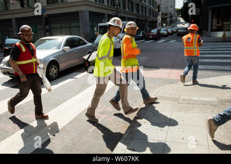Construction workers leaving the job site. Downtown Los Angeles, California, United States of America Stock Photo