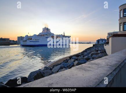 The Brittany Ferries boat Normandie passenger and car ferry sailing into Portsmouth harbour oat dusk, Hampshire England UK Stock Photo