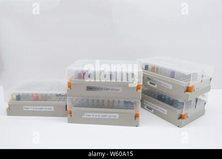 Laboratory research.  A bunch of laboratory bulbs in the box close up isolated on white. Pharmacy factory. Scientific bio medicine modern technology Stock Photo