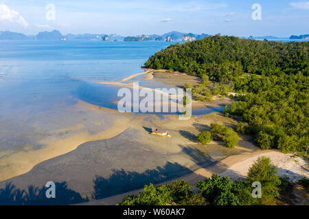 Aerial view of a beautiful tropical sandy beach at low tide in late evening golden sunshine Stock Photo