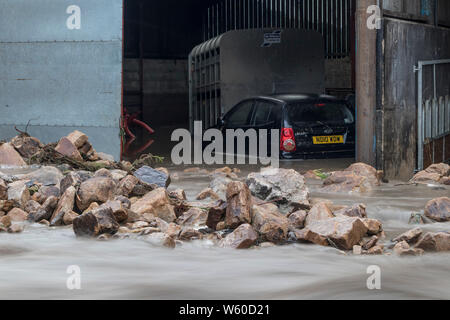 Holme Farm, Arkengarthdale, North Yorkshire UK. 30th July 2019. UK Weather.  Scenes of devastation as torrential rain causes flash flooding which swept through Holme Farm in Arkengarthdale damaging buildings and sweeping some animals away. In nearby Swaledale a bridge also collapsed. Credit: David Forster/Alamy Live News Stock Photo