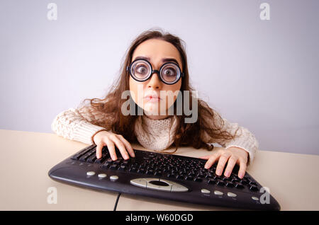 The funny nerd girl working on computer Stock Photo