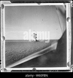 Aerial of US invasion of Engebi Island in Eniwetok atoll. Flares (left ...