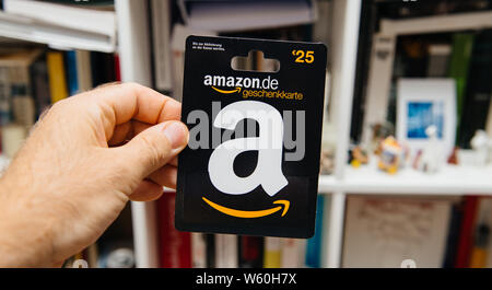 Strasbourg, France - Jun 26, 2018: Man hand holding Amazon Gift card worth 25 euros Amazon.De Germany Geschenkkarten Stock Photo