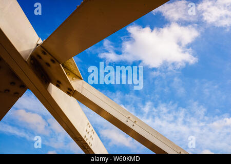 Reinforcement of the metal structure of a bridge, with white steel beams. Stock Photo