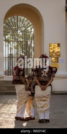 Kandy, Sri Lanka - 09-03-24 - Two Men and a Boys Wait for Wedding Couple.