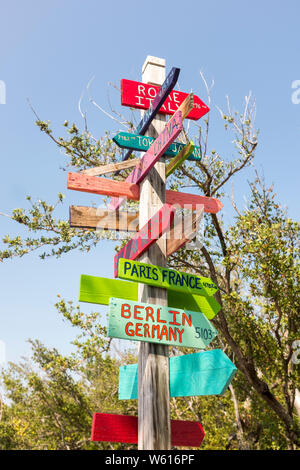 Colorful hand-made wooden arrows showing directions and distances to various cities at Bahia Honda State Park in Florida, USA Stock Photo
