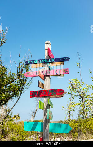 Colorful wooden arrows showing directions and distances to various cities around the world at Bahia Honda State Park in Florida, USA Stock Photo