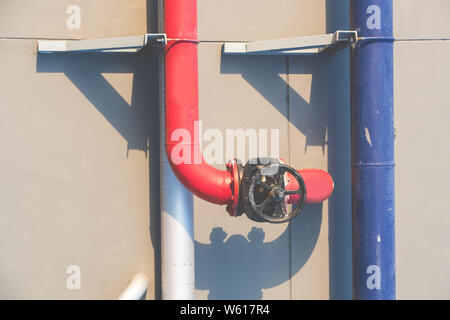 water pipes on building wall Stock Photo