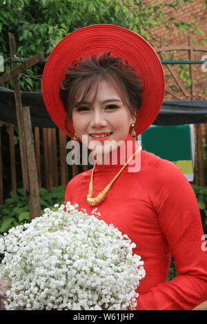 photo of beautiful bride wearing a red long dress Stock Photo