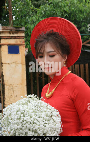photo of beautiful bride wearing a red long dress Stock Photo