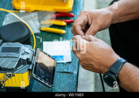 Device for mounting optical cable. Optical internet Technology concept. Optical fiber assembly. Stock Photo
