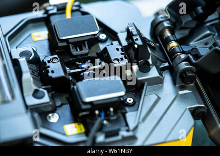 Device for mounting optical cable. Optical internet Technology concept. Optical fiber assembly. Stock Photo