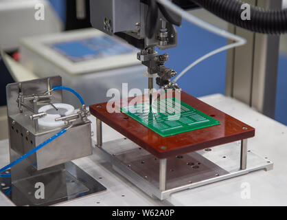 Automated robot soldering electronic PCB circuit board Stock Photo