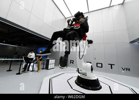 A visitor tries out a VR device to take a roller coaster ride at the