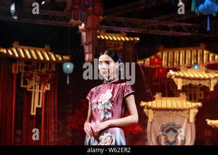 A Model Displays A Traditional Chinese Wedding Dress At The - 