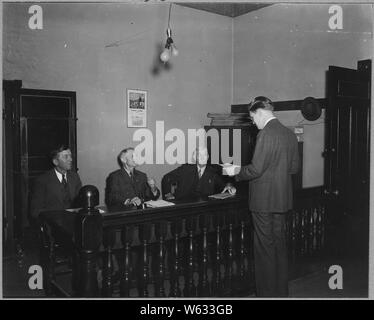 Charles County, Maryland. The executive secretary of the Charles County Welfare Board presents a pro . . .; Scope and content:  Full caption reads as follows: Charles County, Maryland. The executive secretary of the Charles County Welfare Board presents a problem before the county commissioners at their regular monthly meeting, at LaPlata. Around these three Charles County commissioners, county business, problems and policies revolve. Stock Photo