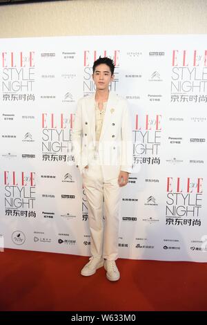 Chinese actor Connor Leong or Liang Jingkang of the new lineup of Chinese boy group F4 arrives on the red carpet for the 'ELLE China 30th Anniversary' Stock Photo