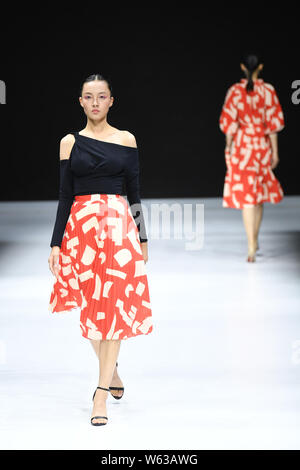 A model displays a new creation at the JD x Something fashion show during the 2018 Beijing Fashion Week in Beijing, China, 17 September 2018. Stock Photo