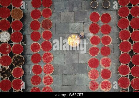 An aerial view of villagers airing and drying crops at Chengkan Ancient Village in Huangshan city, east China's Anhui Province, 12 September 2018. Stock Photo