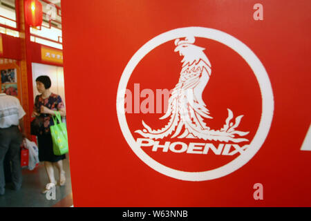 --FILE--People visit the stand of bicycle maker Shanghai Phoenix during a fair in Shanghai, China, 15 September 2011.   Chinese bike-sharing platform Stock Photo