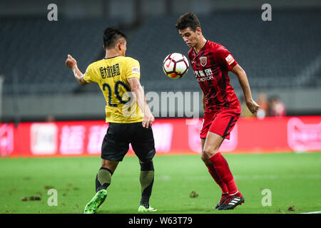Brazilian football player Oscar, right, of Shanghai SIPG, challenges