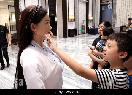 Humanoid robot Madam Wei, sister of robot Jia Jia, welcomes guests at a forum in Hefei city, east China's Anhui province, 18 September 2018.   Billed Stock Photo