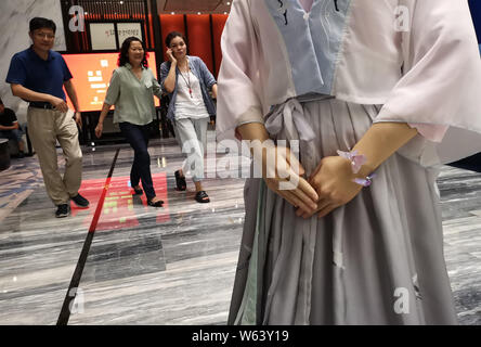 Humanoid robot Madam Wei, sister of robot Jia Jia, welcomes guests at a forum in Hefei city, east China's Anhui province, 18 September 2018.   Billed Stock Photo