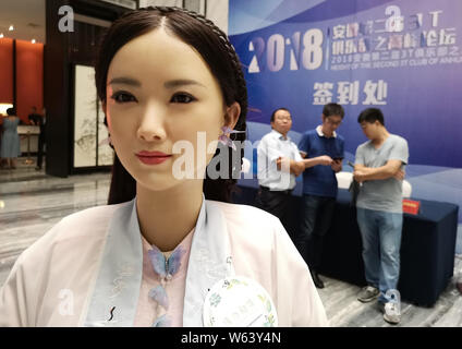 Humanoid robot Madam Wei, sister of robot Jia Jia, welcomes guests at a forum in Hefei city, east China's Anhui province, 18 September 2018.   Billed Stock Photo