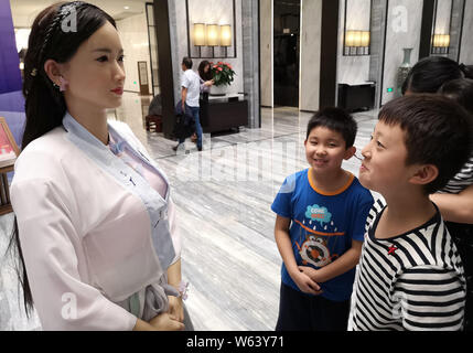 Humanoid robot Madam Wei, sister of robot Jia Jia, welcomes guests at a forum in Hefei city, east China's Anhui province, 18 September 2018.   Billed Stock Photo