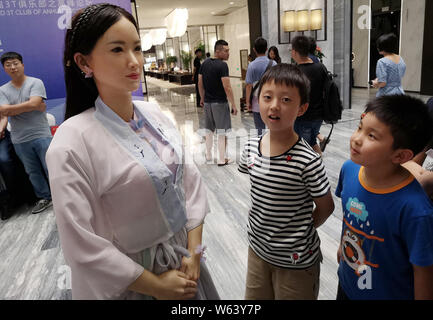 Humanoid robot Madam Wei, sister of robot Jia Jia, welcomes guests at a forum in Hefei city, east China's Anhui province, 18 September 2018.   Billed Stock Photo